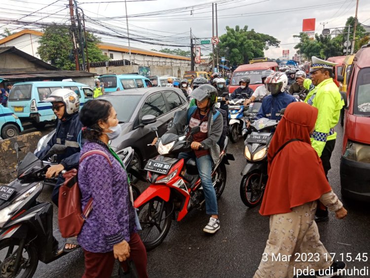 Kanit Lantas Polsek Cikupa Polresta Tangerang Giat Laksanakan Pengaturan Arus Lalu Lintas Di Sore Hari Diguyur Hujan